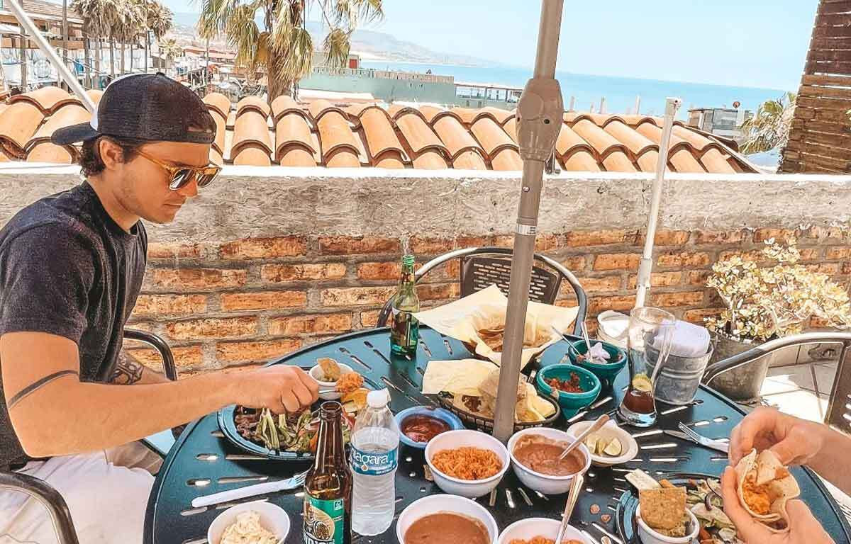 Enjoying fresh lobster in Puerto Nuevo, Baja California, Mexico, a culinary highlight for surfers in Mexico.