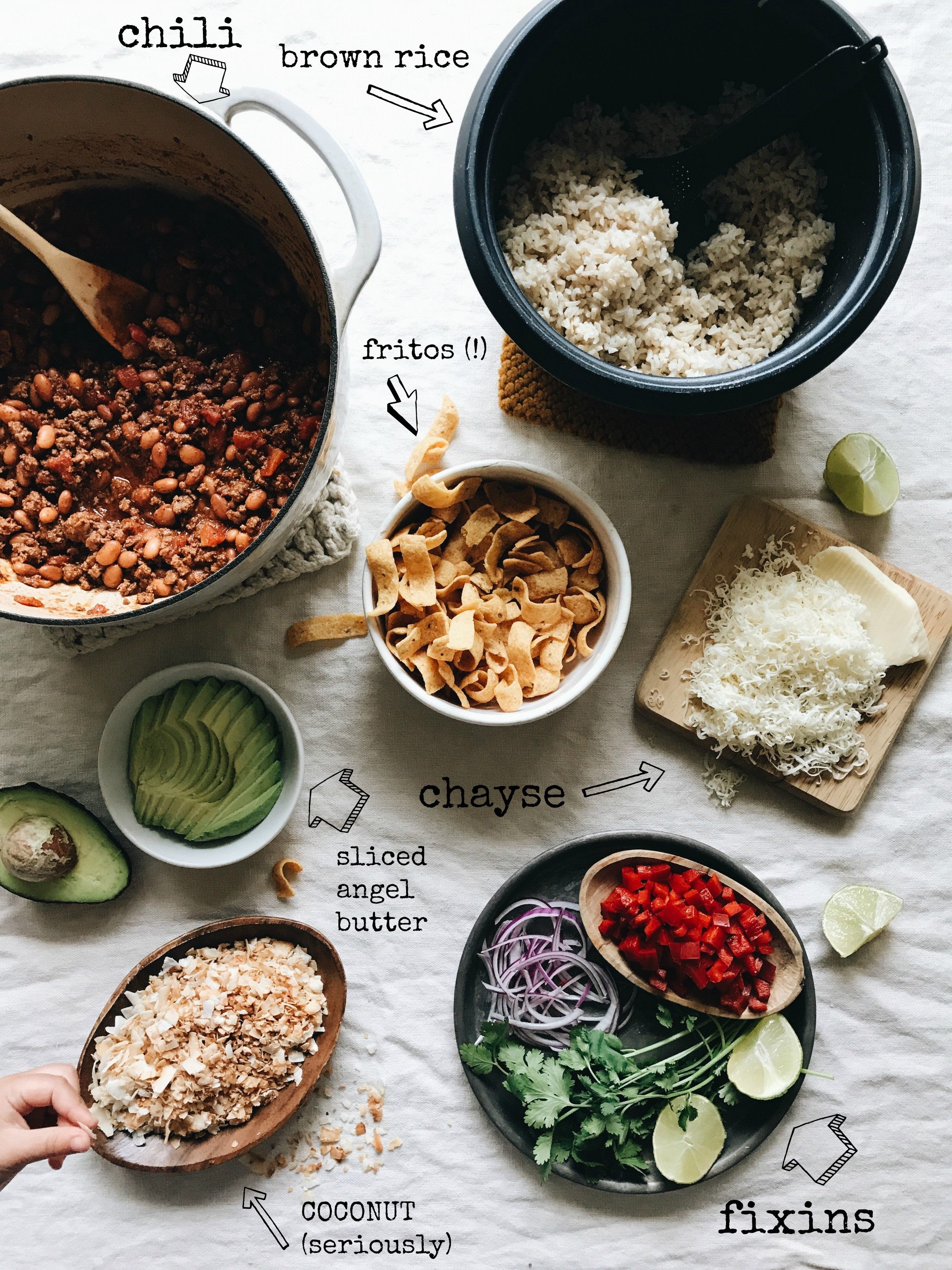 Fresh ingredients for Mexican Fiesta Bowls including ground beef, rice, vegetables, and toasted coconut.