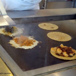 Tacos being grilled with cheese at Puesto in La Jolla