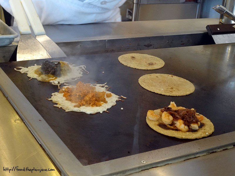 Tacos being grilled with cheese at Puesto in La Jolla