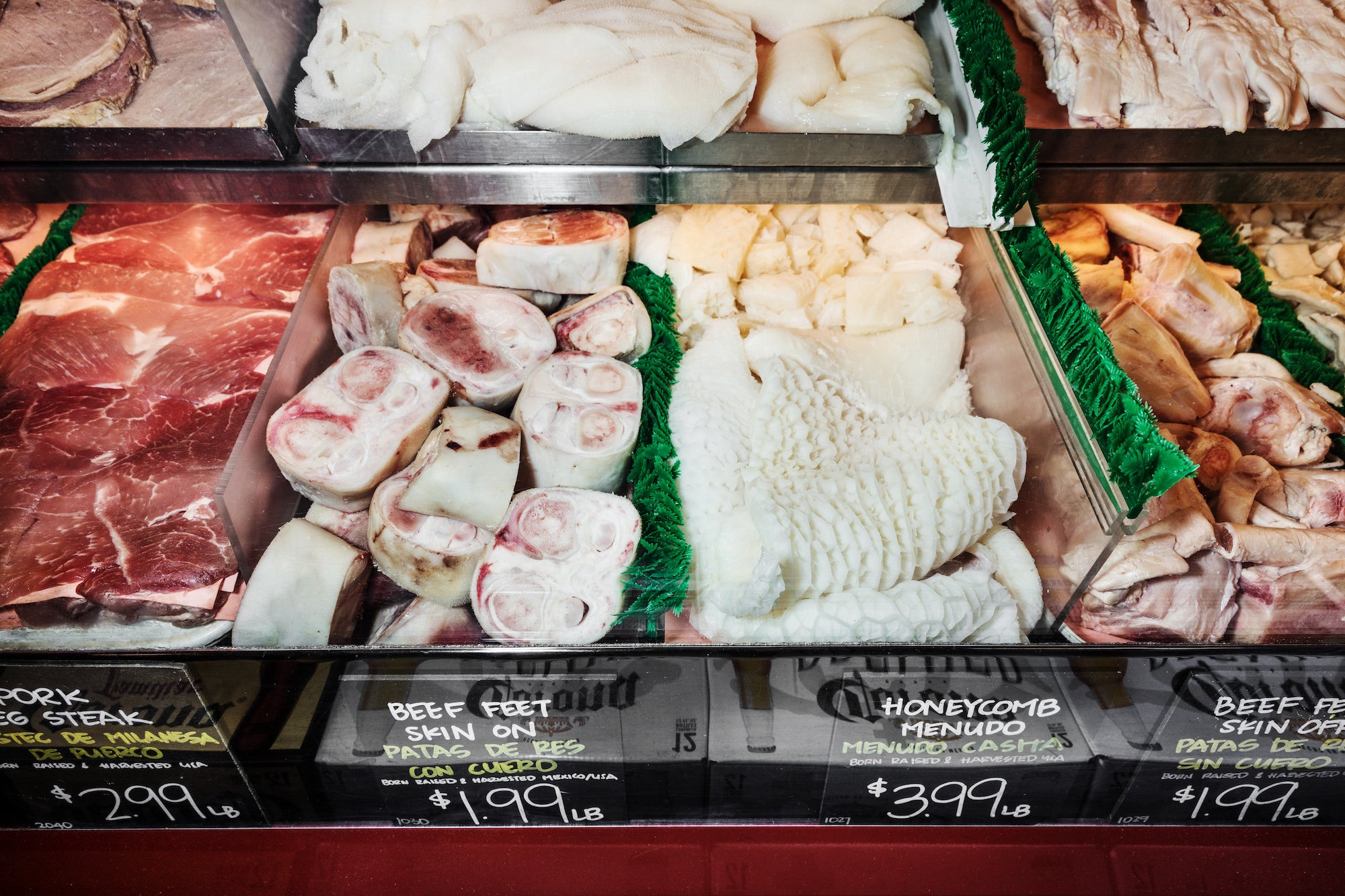 A customer selecting produce in a Mexican grocery store, showcasing the everyday shopping experience and the importance of fresh ingredients in Mexican cuisine.