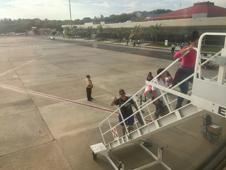 man walks up stairs to volaris flight, which is one of the mexican airlines