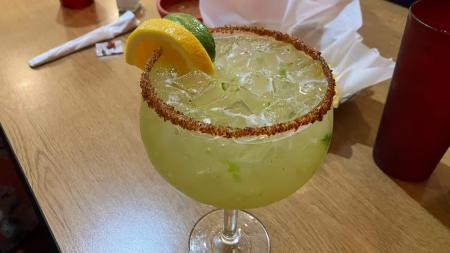 A vibrant Jalapenos Margarita at Iguanas Mexican Restaurant in Brownsburg, Indiana, showcasing the restaurant's colorful drink options.