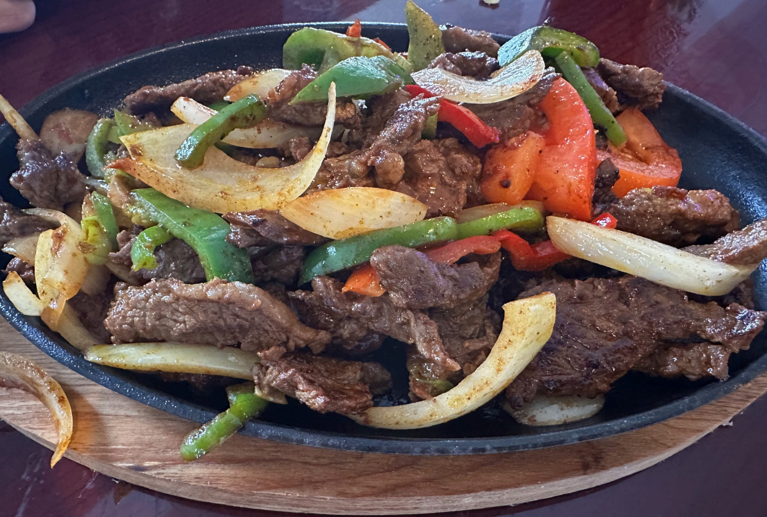 Steak Fajitas at Fiesta Azul, showcasing sizzling steak and grilled vegetables