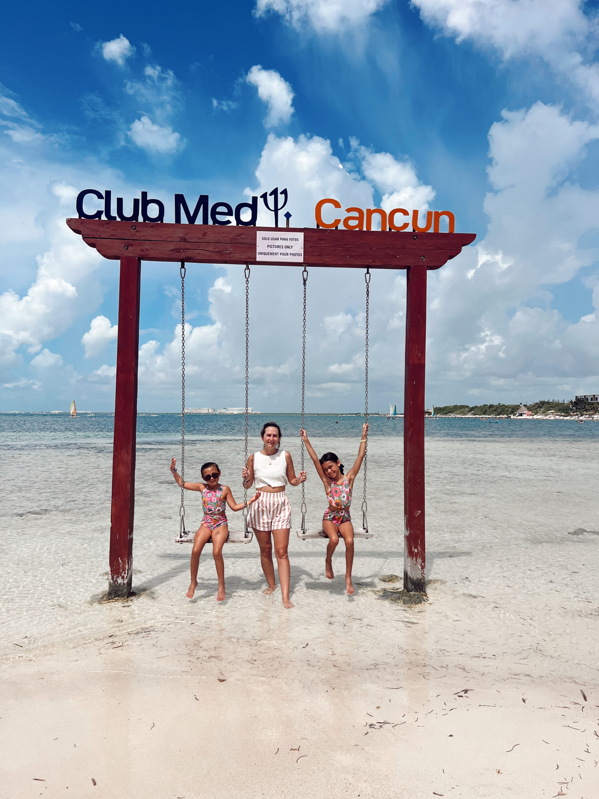 Children playing happily in the shallow water at Club Med Cancun, emphasizing the safe and enjoyable beach environment