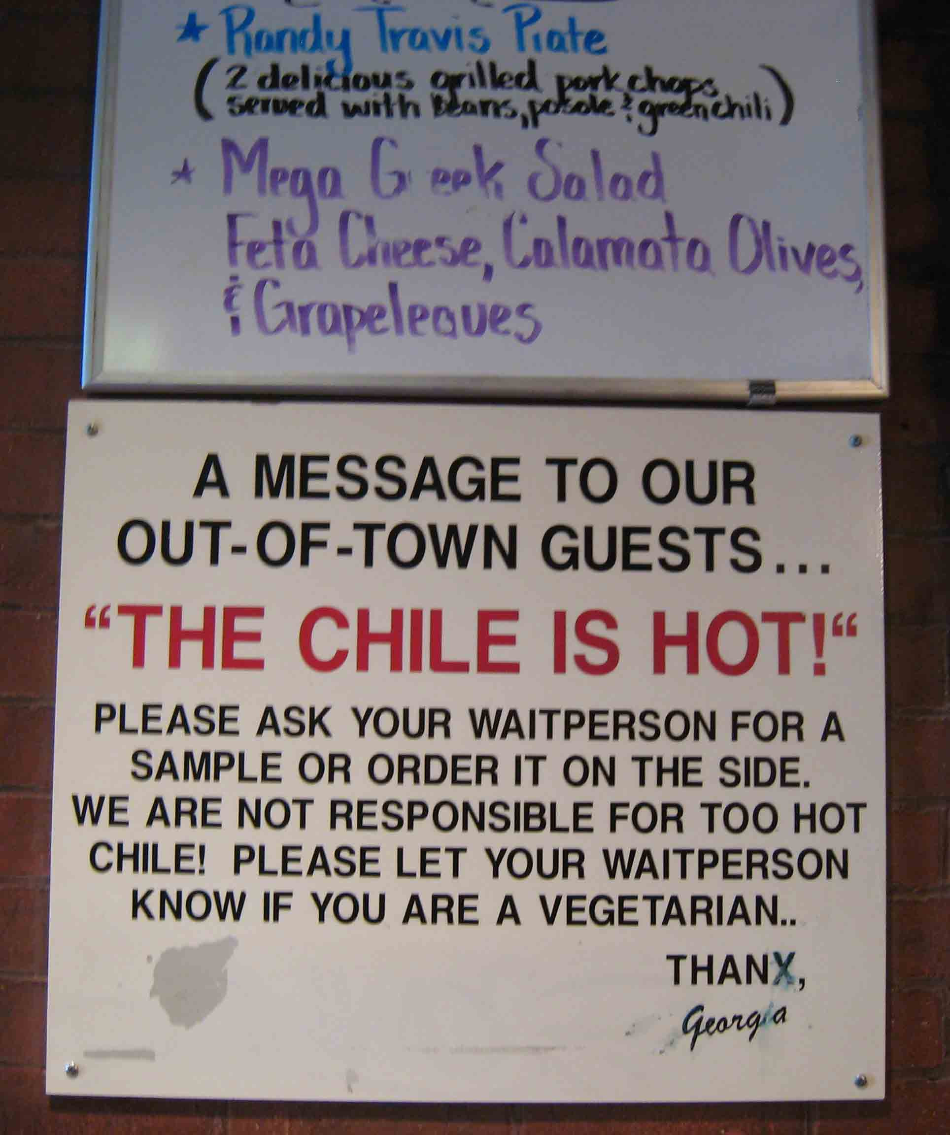 A humorous warning sign about the spiciness of the chile at Tomasita's Restaurant