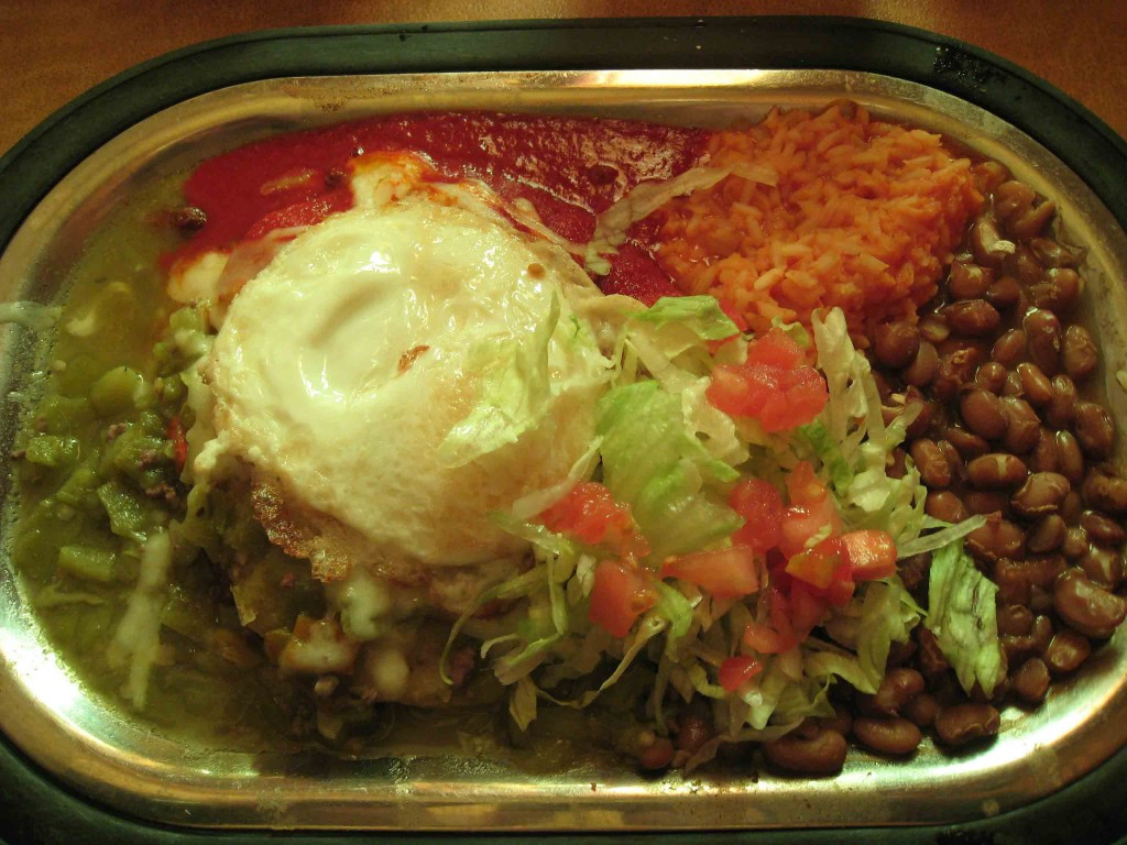 A plate of ground beef enchiladas topped with a fried egg at Tomasita's