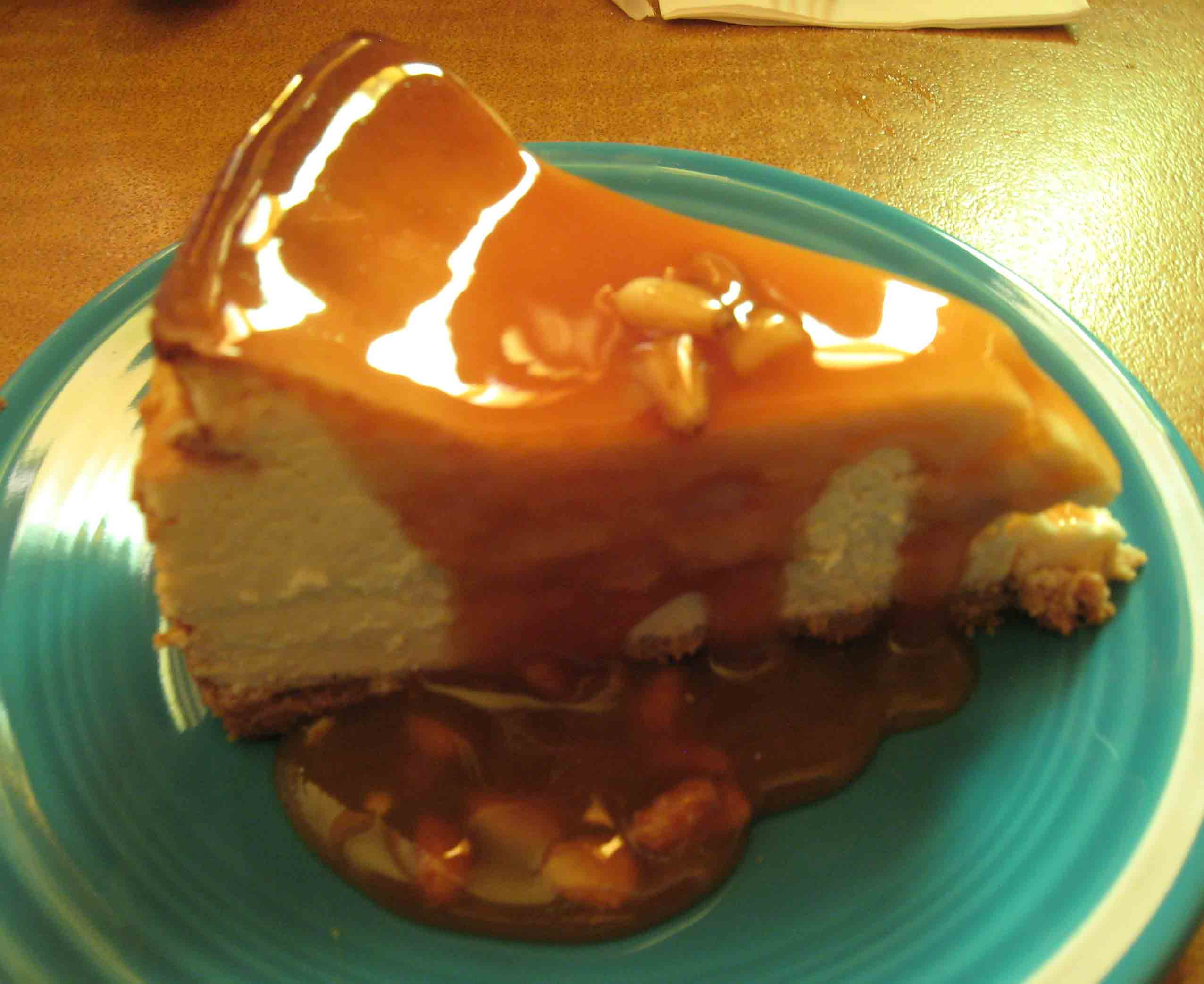 A slice of piñon cheesecake with caramel, a rich dessert option at Tomasita's