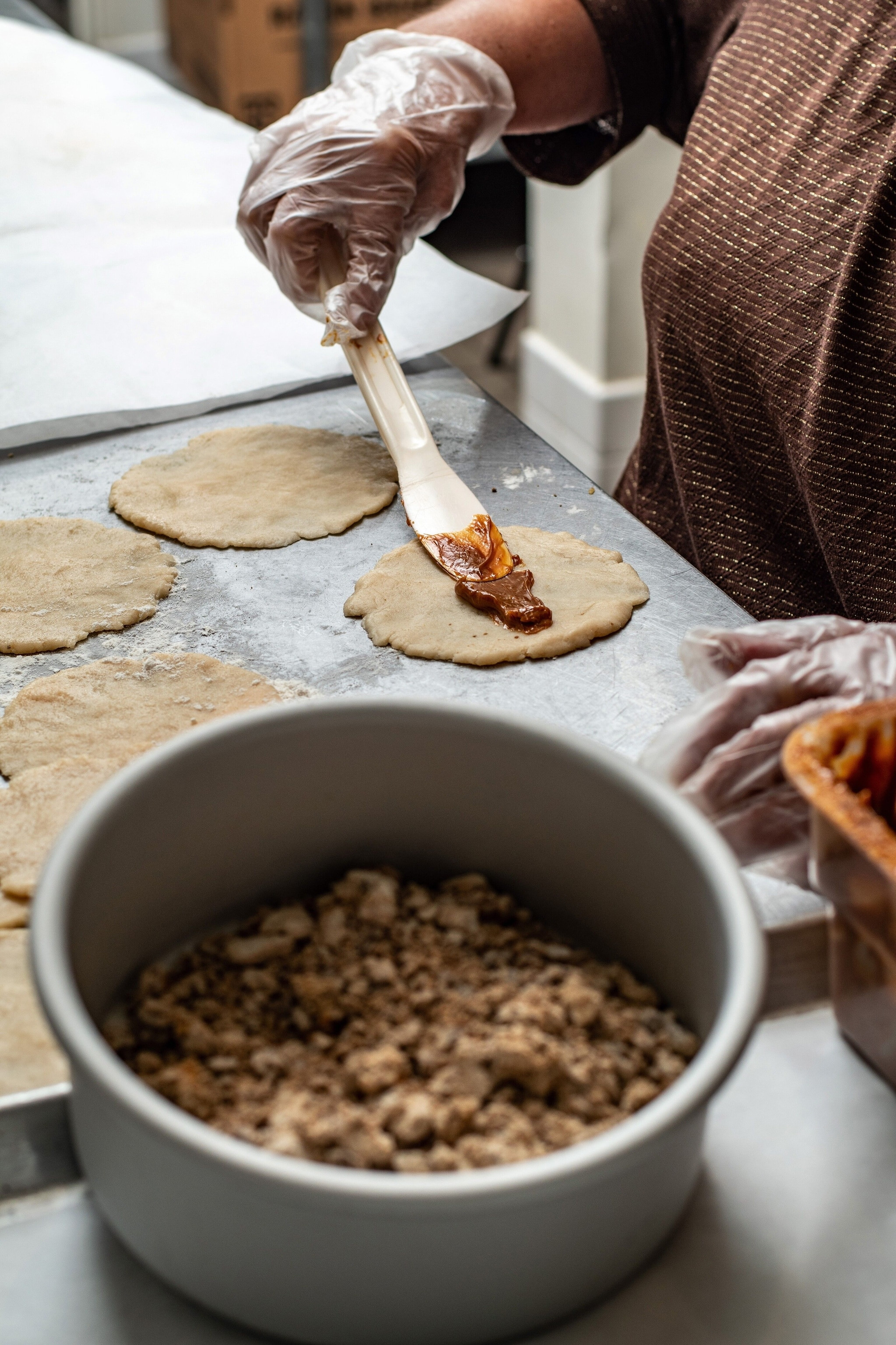 Maria Ofilia Almazan Serecer preparing traditional coyotas with cajeta at Dolce Pastello, showcasing the artisanal process.