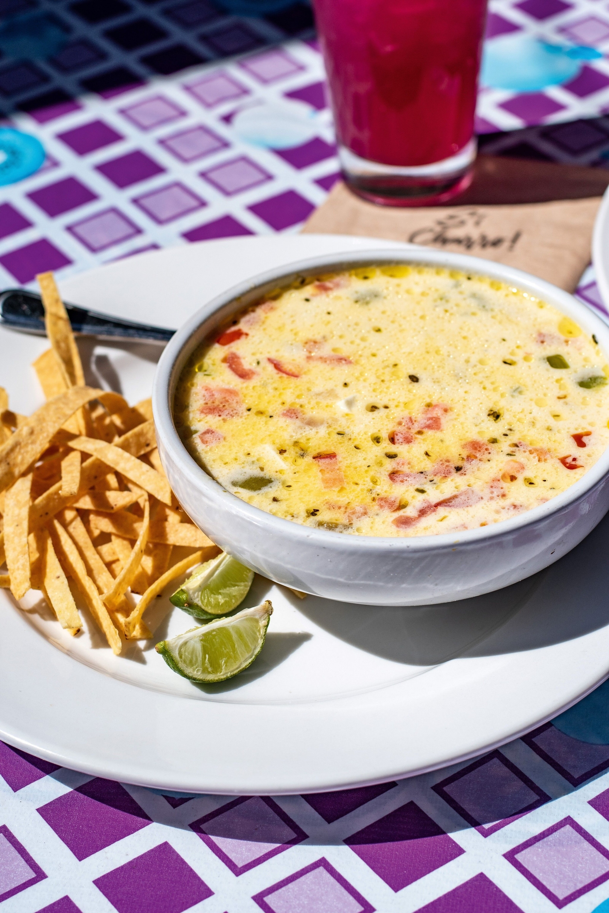 El Charro Cafe's Caldo de Queso and a Prickly Pear Margarita, showcasing a classic soup and regional drink.