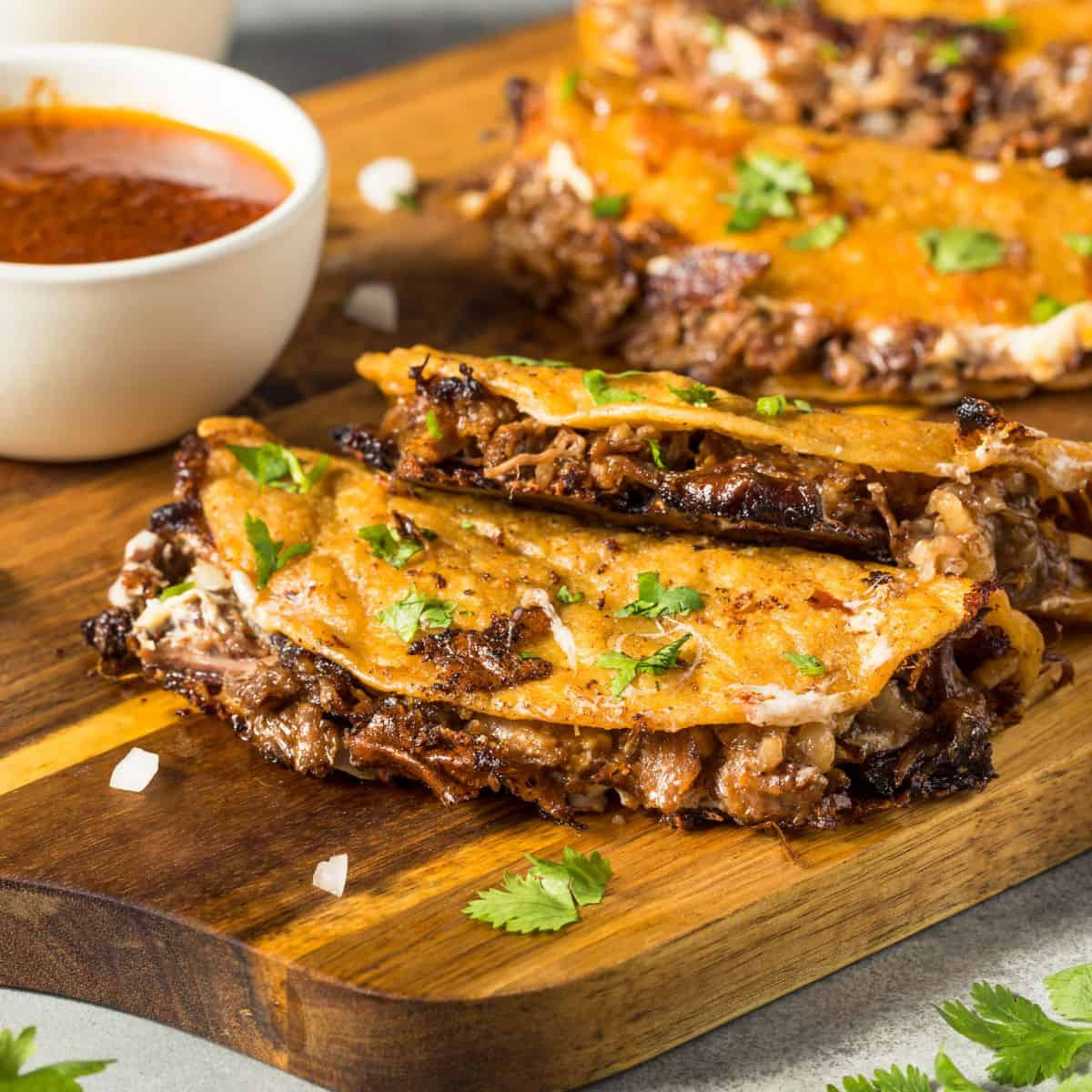 Birria tacos, showcasing the rich color and tender meat.