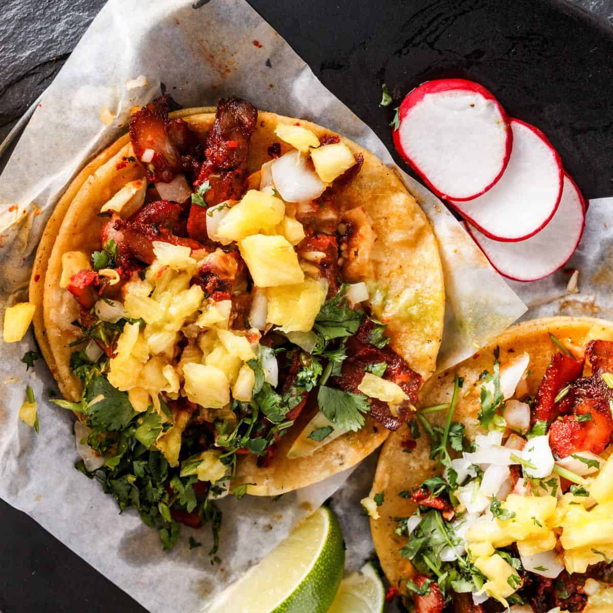 Al Pastor tacos, showcasing the vibrant color and typical presentation.
