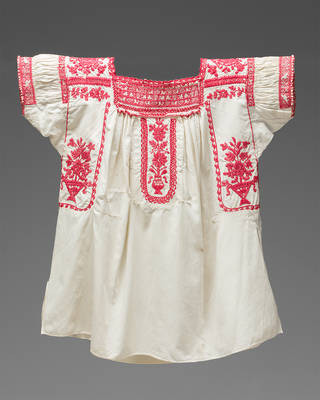 An embroidered blouse from Puebla, displaying floral designs