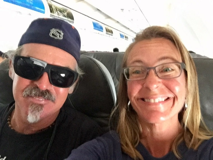 smiling couple on a plane