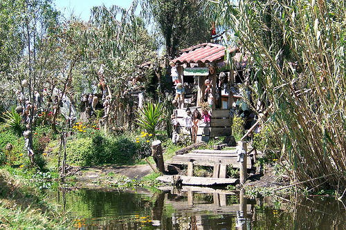 A dense collection of dolls hanging from trees on Doll Island, creating a surreal and unsettling scene.