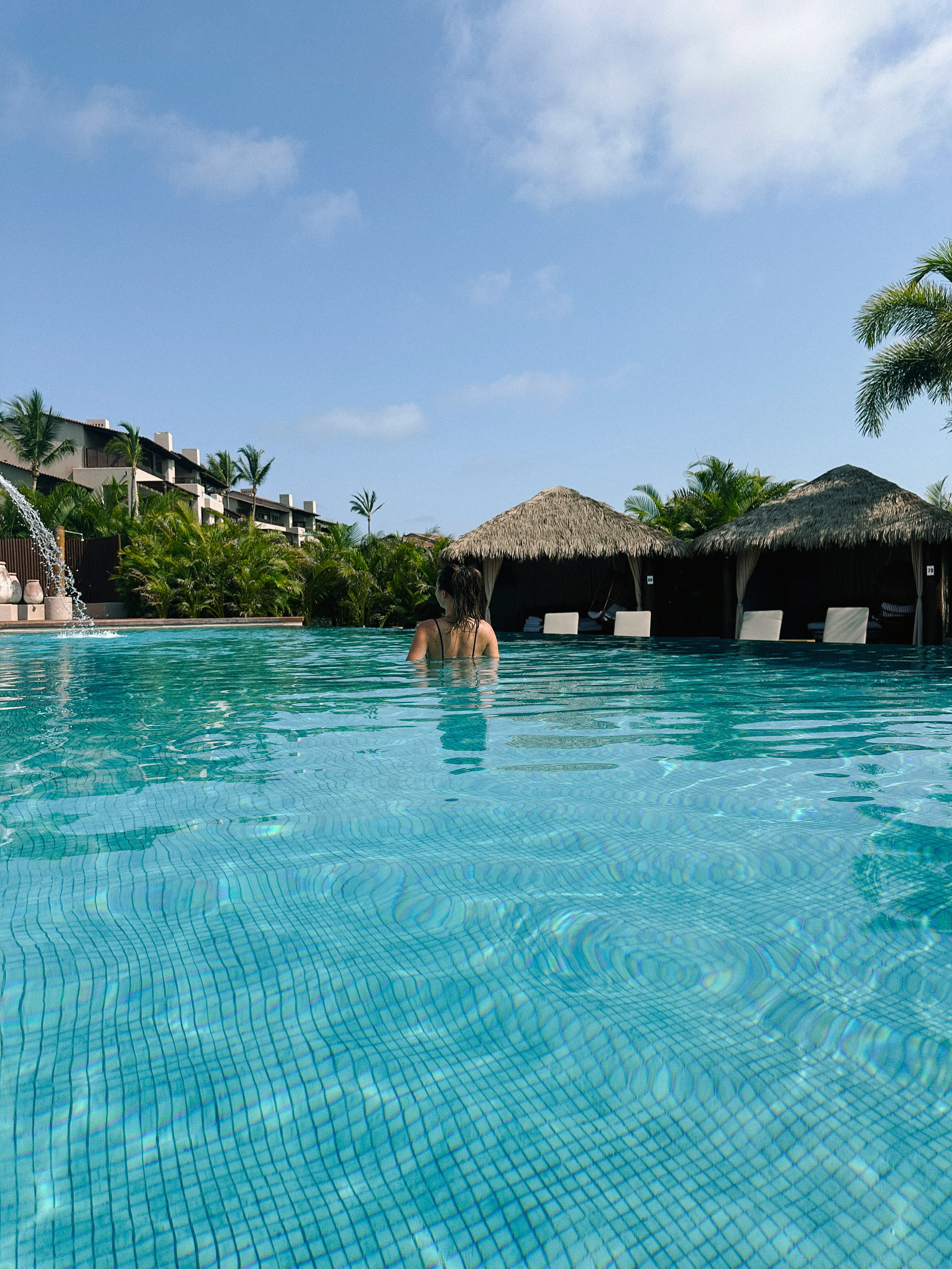 Woman relaxing in Tamai adults-only pool at Four Seasons Resort Punta Mita