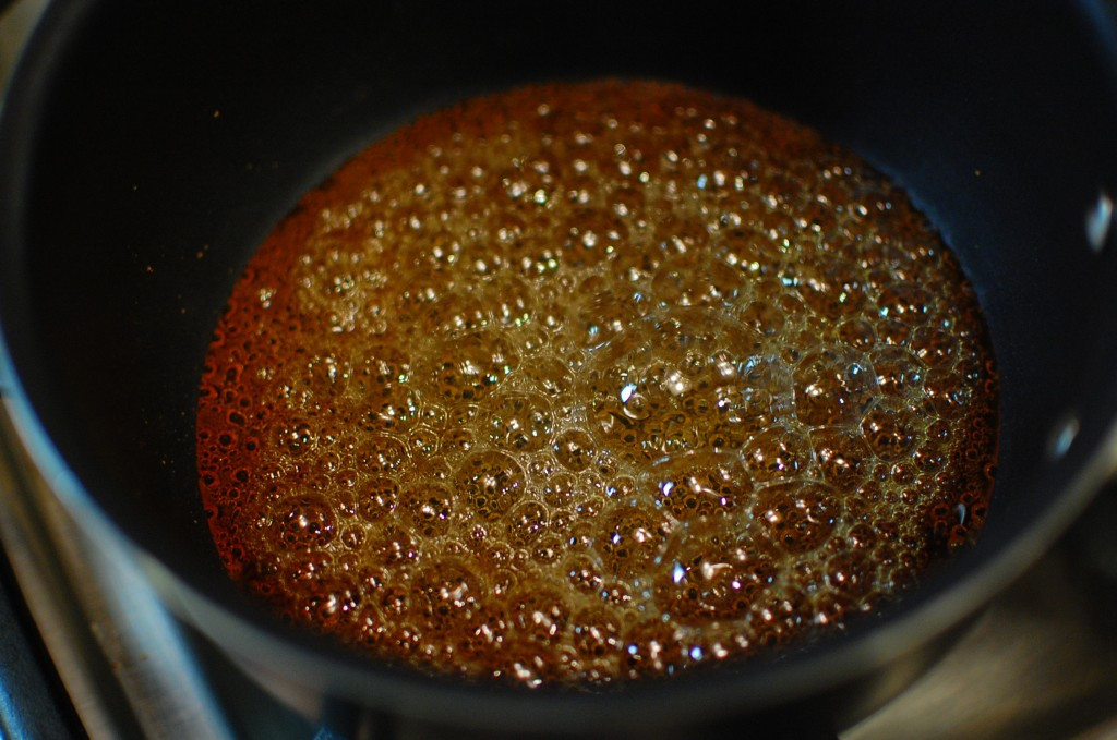 Caramel being poured into ramekins.