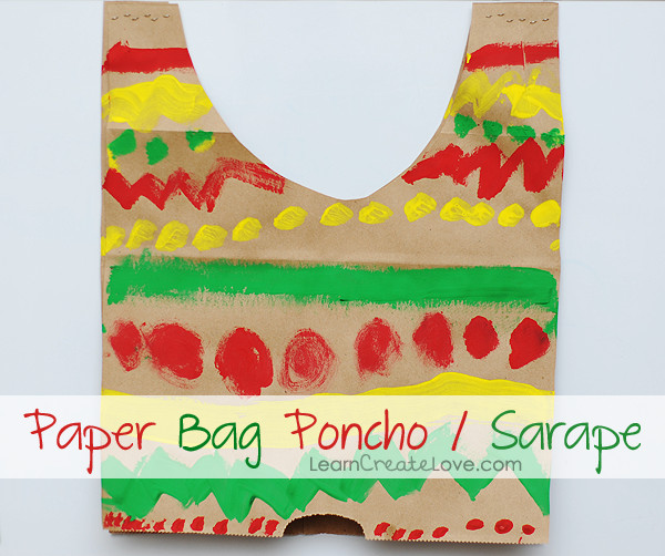 alt: A child wearing a paper bag sarape poncho.