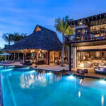 Luxury villa with lit patio and large pool