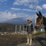 Jose Marcos, a local farmer, gazes warily at Popocatepetl volcano, locally known as El Popo, reflecting the community's deep connection to the volcano's spirit.