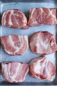 Pork covered in kosher salt for dry brining