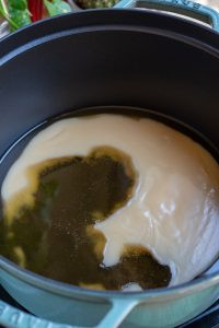 Melting the lard in a large pot over medium heat