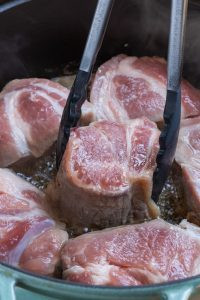 Frying pork butt chunks in melted lard