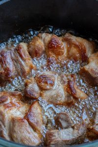 Flipping pork over to repeat on the other side