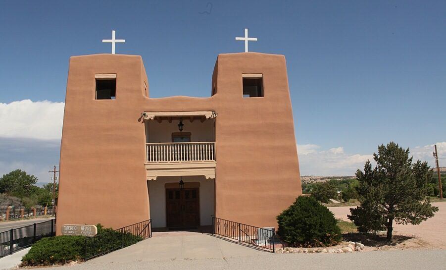 The Adobe Sacred Heart Catholic Church from the front and blue skies