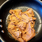 Frying refried beans with onion and garlic