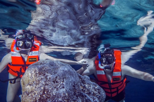 Couple snorkeling in sacred Mayan cenotes near Progreso