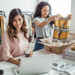 Two online sellers preparing to ship USPS packages.