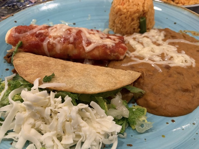 Don Julio combo alt text: A &quot;pick 2&quot; dinner combo at Don Julio with a ground beef taco and a chicken enchilada, served with rice and beans