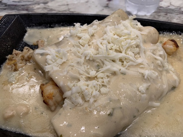 Don Julio enchiladas alt text: Enchilada Puerto Vallarta at Don Julio, featuring seafood wraps with a creamy sauce
