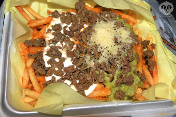 Carne Asada Fries from Albertaco’s in Cypress, CA, a popular snack made of french fries, carne asada, cheese, guacamole, and sour cream