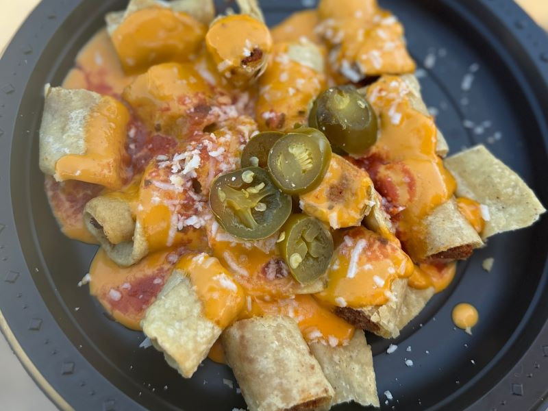 El Indio San Diego taquitos showcase crispy, rolled tacos topped with guacamole and cheese, a beloved dish with over 80 years of history