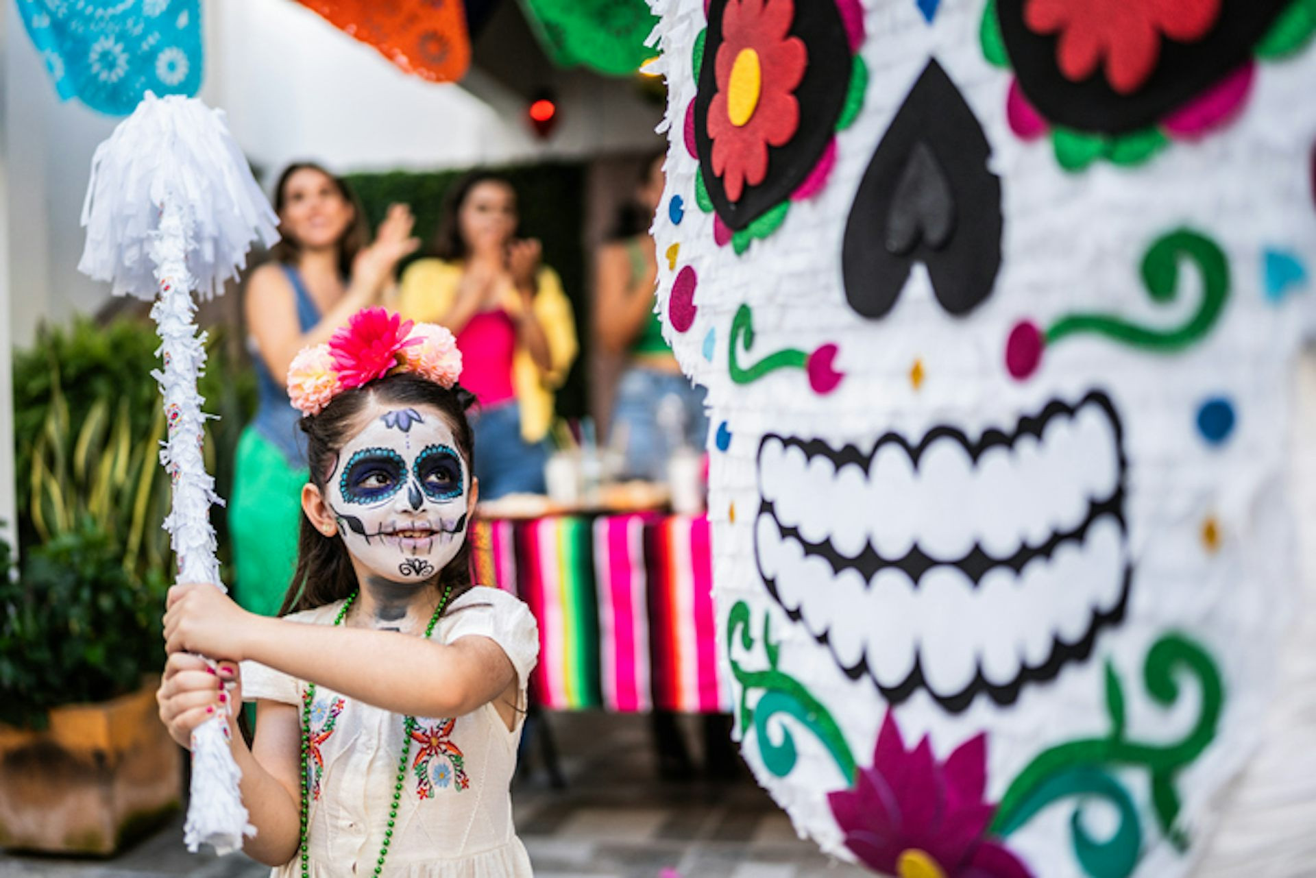 A colorful Día de Muertos altar filled with ofrendas, including food, drinks, and photos, honoring deceased loved ones.