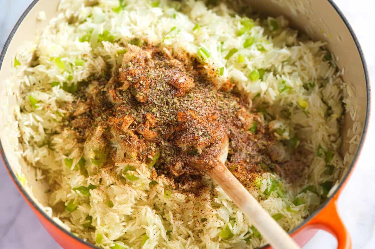 Toasting rice with spices in a pot for Mexican rice