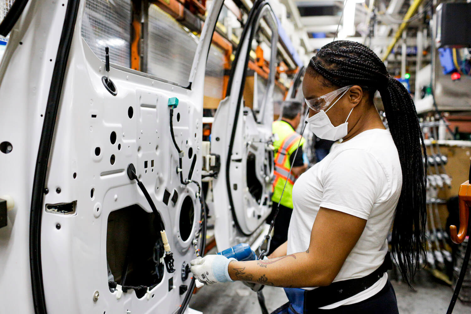 A woman assembling a door of a Ford F-150 full-size half-ton pickup truck at the Dearborn plant in the U.S.A.