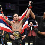 Max Holloway celebrates his victory at UFC 240