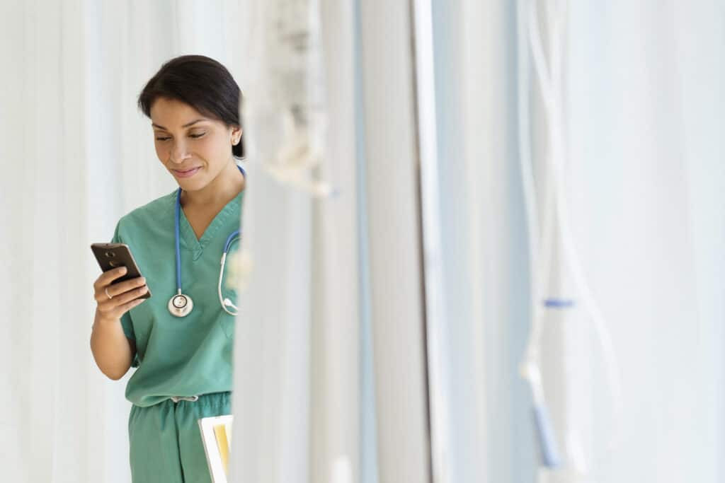 Healthcare professional looking at their mobile phone
