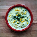 Rajas con Crema served in a traditional Mexican bowl, showcasing the creamy texture and poblano pepper strips.