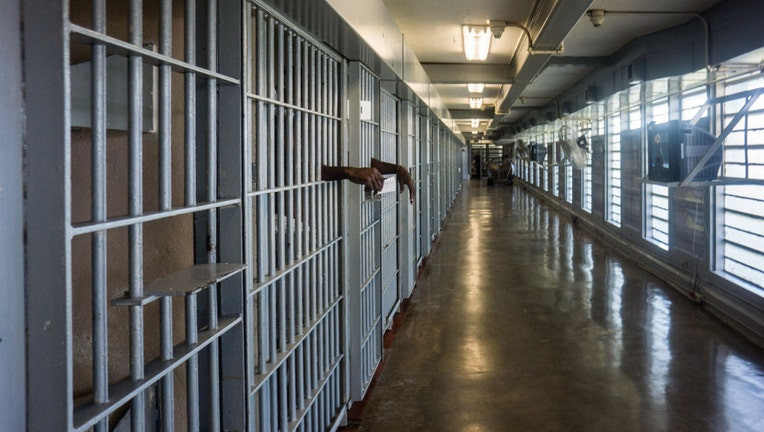 Prisoner's hands inside a jail cell, potentially alluding to incarceration following investigations related to drug trafficking and money laundering, sparking rumors about international connections.