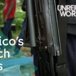 Mexican protesters holding signs denouncing violence and corruption