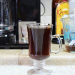 Mexican coffee, infused with cinnamon and served in a clear glass mug
