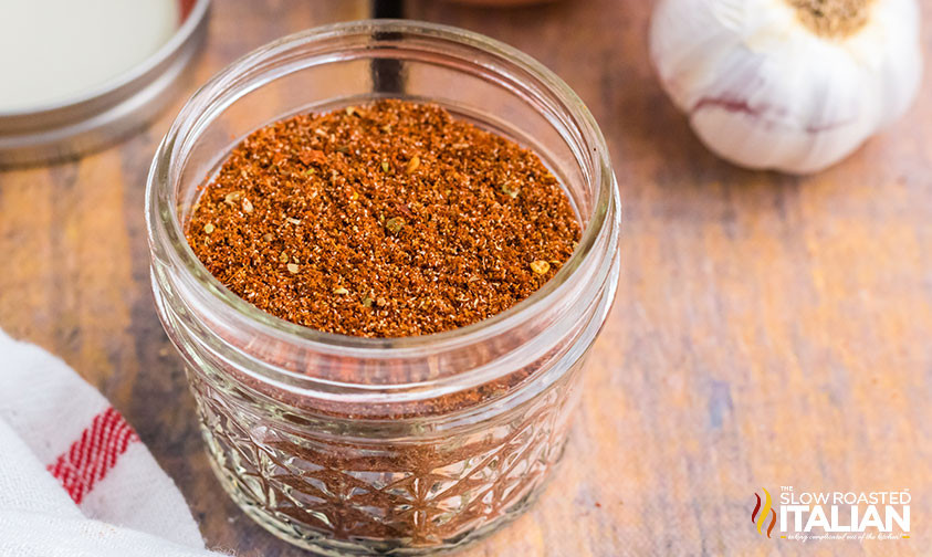 Homemade Mexican seasoning in a glass jar, showcasing the rich colors and textures of chili powder, cumin, and paprika