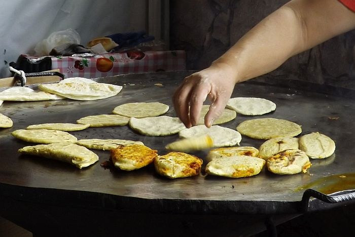 Mexican street food breakfast, including gorditas and tlacoyos, perfect for a quick and tasty morning meal