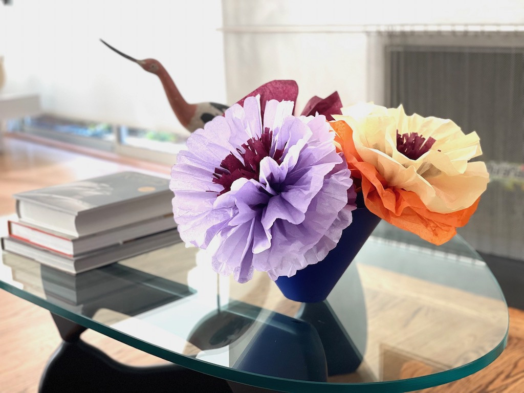 Arrangement of handmade Mexican paper flowers in various colors and sizes, displayed as a vibrant centerpiece.