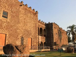 A 16th century construction in stone that looks like a fortress, with arched openings