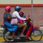 Three people on moterbike